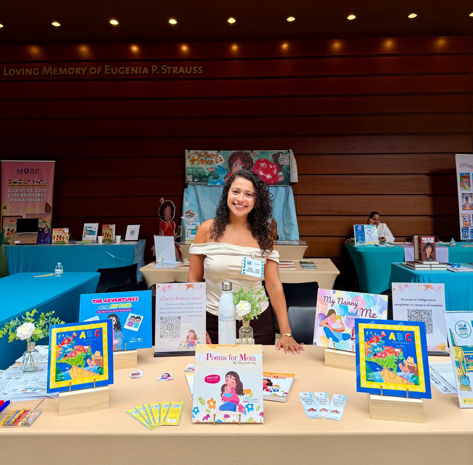 Lorena at her Blossom Little Readers book fair table